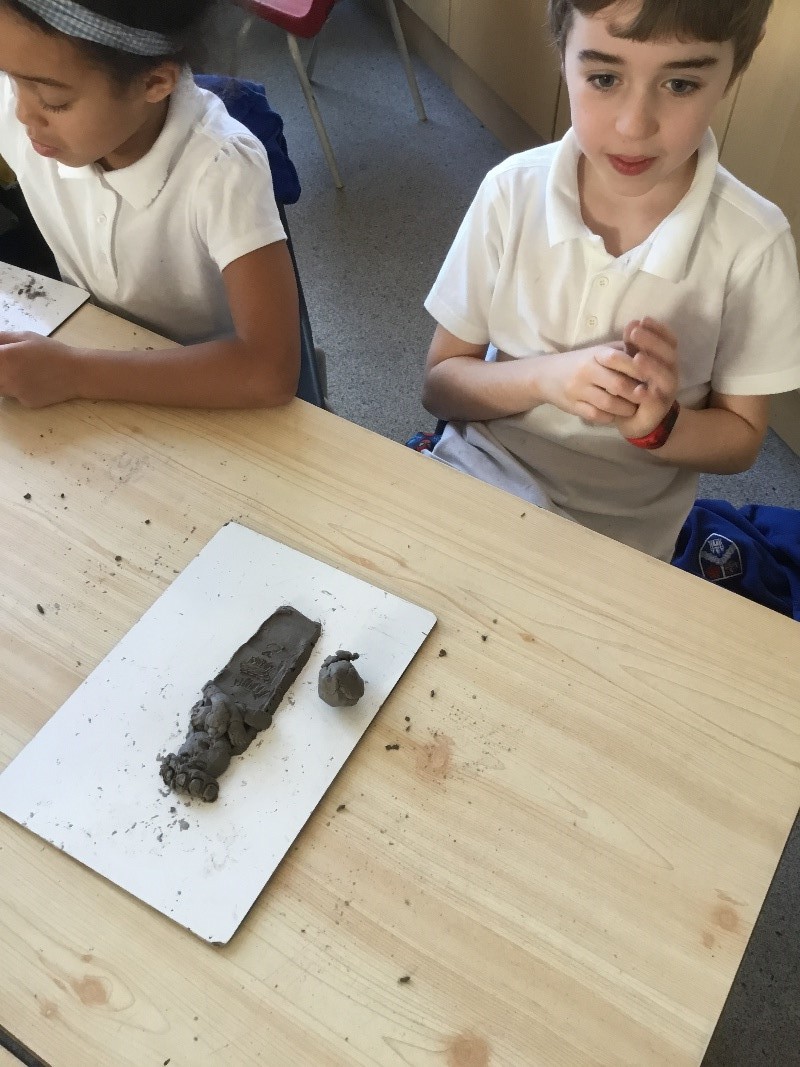 children at table with clay