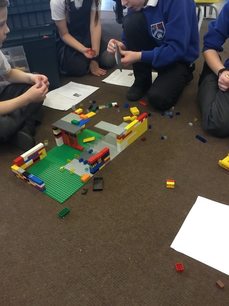 children on floor with lego