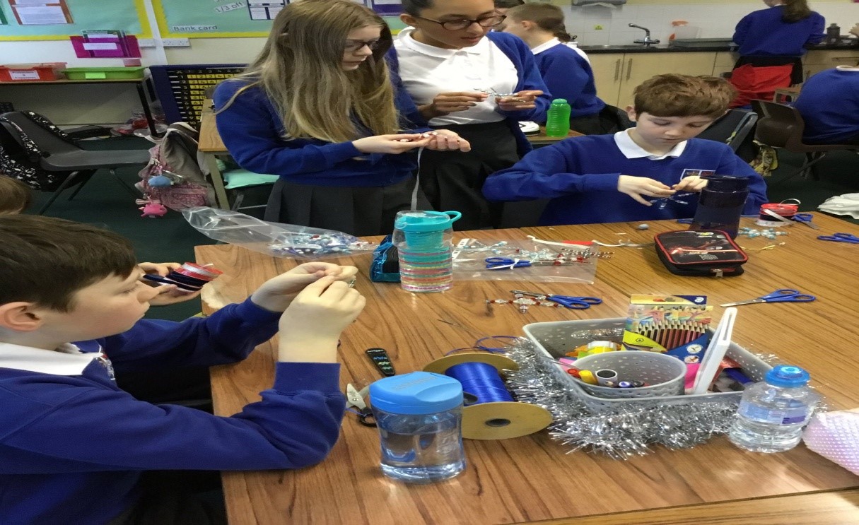 children at table making decorations