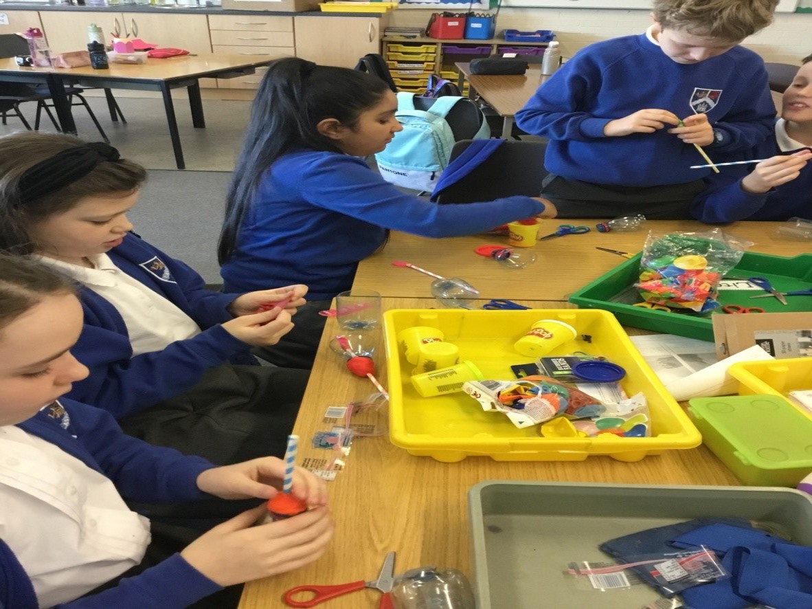 children at desk with experiment