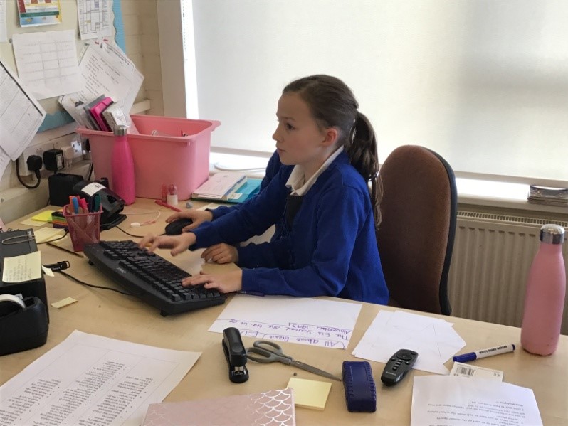 girl at desk typing