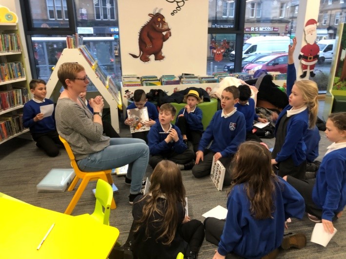 children on floor listening to librarian